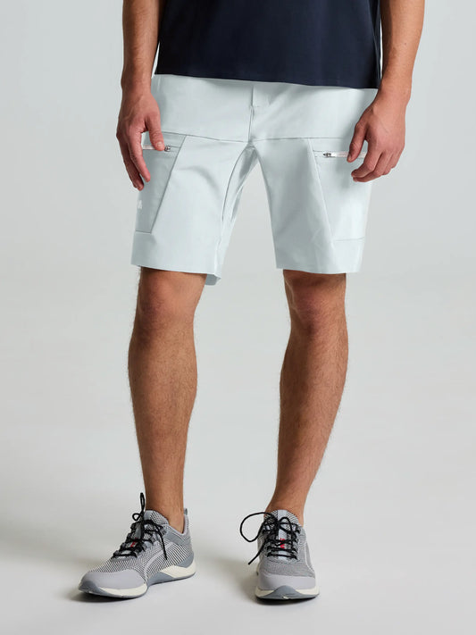 A person wearing SLAM OD CARGO SHORT in CLIFF GREY, made from water-repellent double weave stretch fabric, pairs them with a dark shirt and gray athletic shoes. Only their lower body is visible against a plain light background.