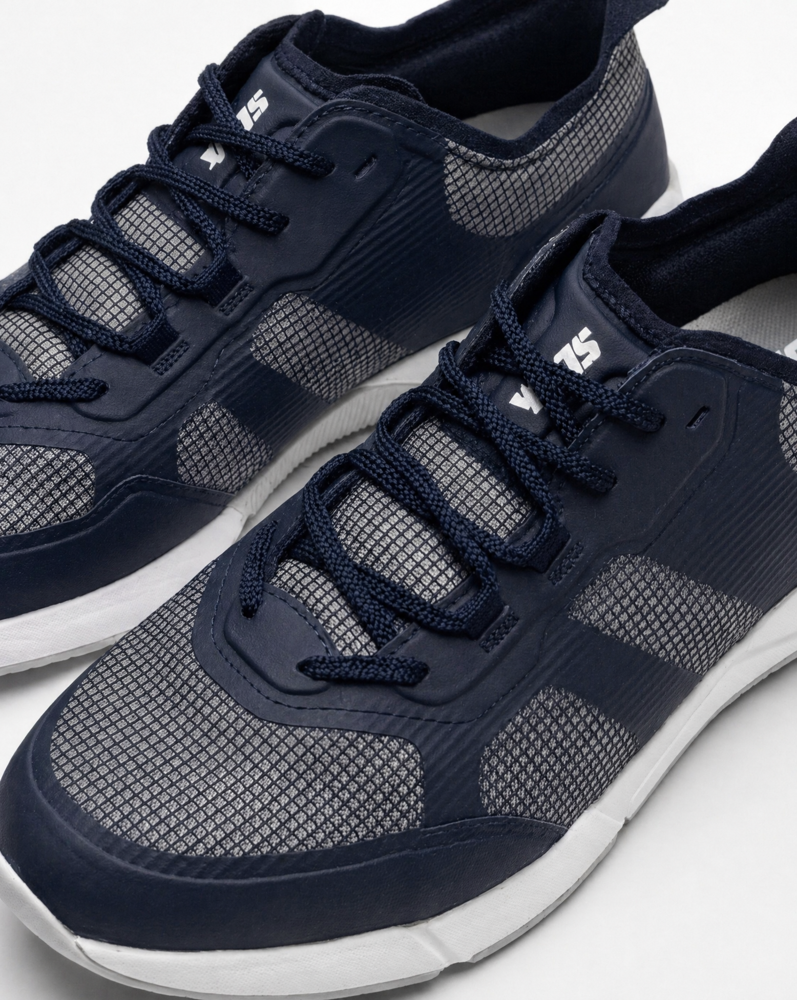 A close-up of SLAM's CREW SHOES in navy blue with gray mesh accents and white soles, shown against a plain white background.
