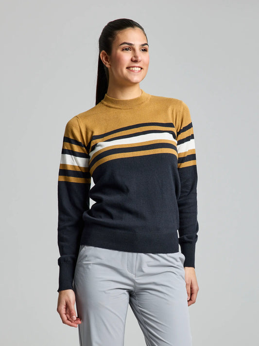 A person beams in the WOMAN JUMPER YONNE CL by SLAM, showcasing mustard (Gran Canyon), white, and dark navy stripes. Their long hair is tied back, paired with light gray pants. This cozy cotton/wool blend sweater is set against a simple light gray background.