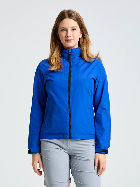 A person stands facing forward, wearing the SLAM WS SAILING JACKET in bright blue and light gray pants, against a plain light background.