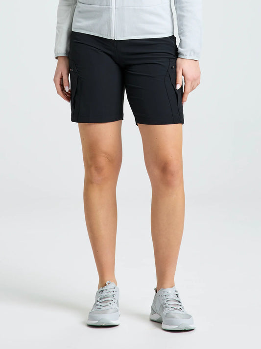 Only the lower half of a person is seen against a plain background, wearing gray athletic shoes and SLAM WS TECH CARGO SHORT in BLACK INK (a water-repellent women’s Bermuda short).