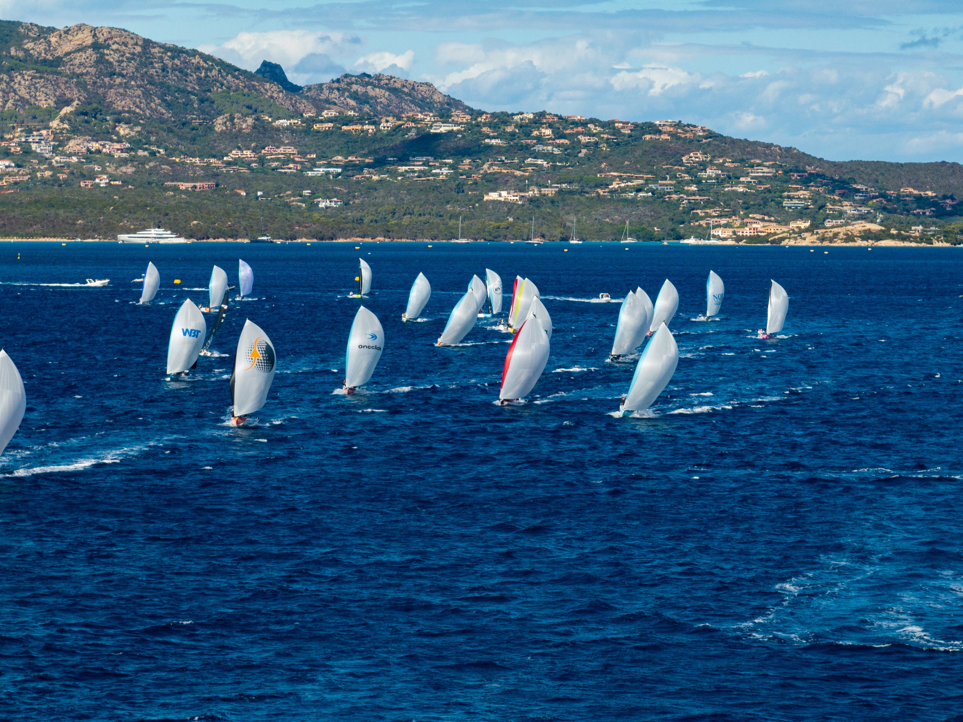 RS21 sailing boats racing close to the shore