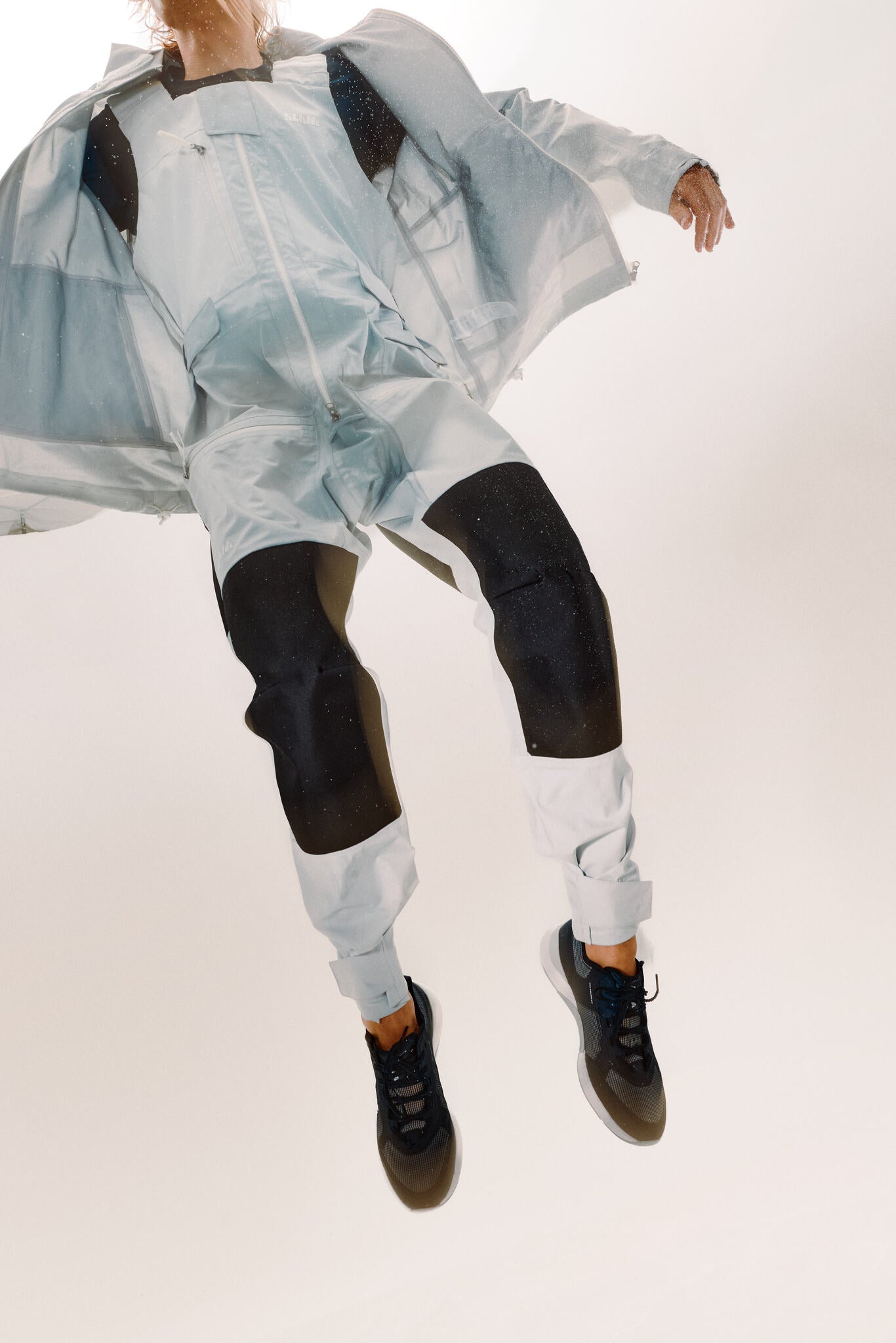 Close-up showing a man who's wearing a grey long john and jacket with abrasion-resistant nylon panels